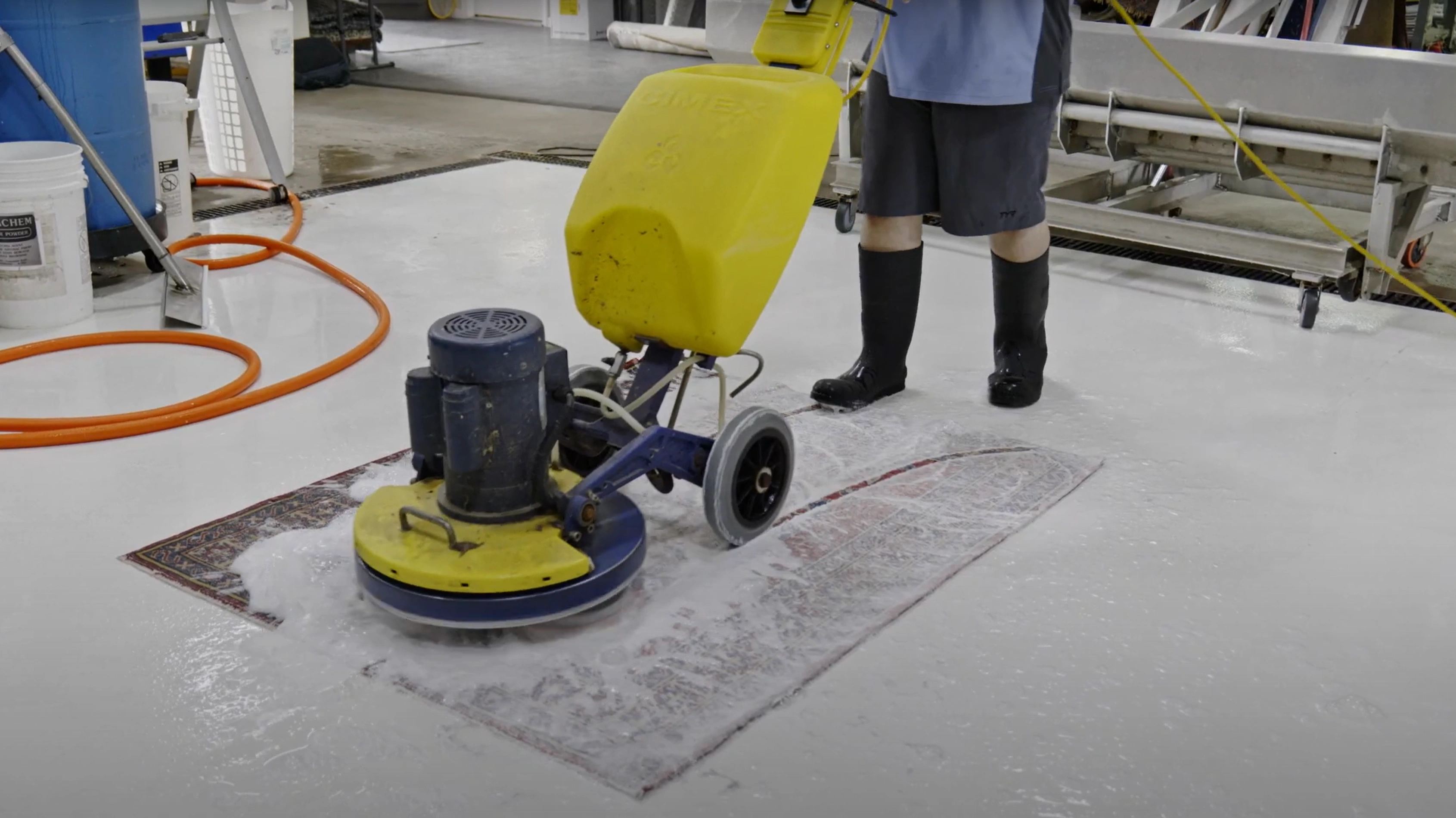 Professional rug cleaning with industrial equipment at Rug Life facility